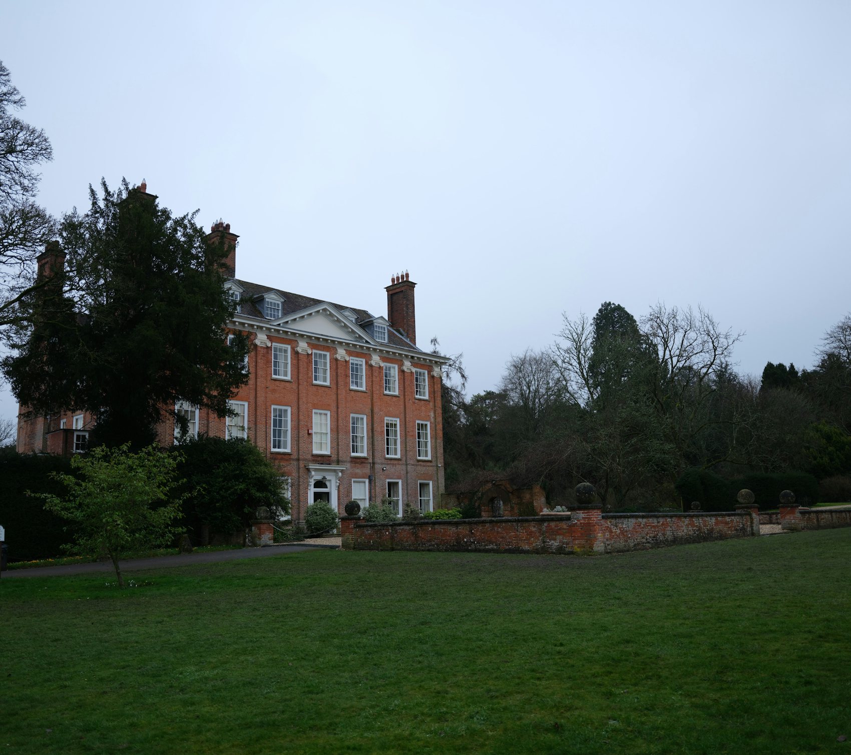 Foxwell House and its lawn on a still afternoon