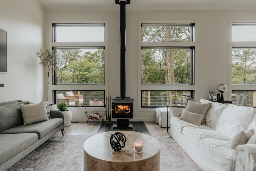 The drawing room, stove lit and tall windows onto the trees